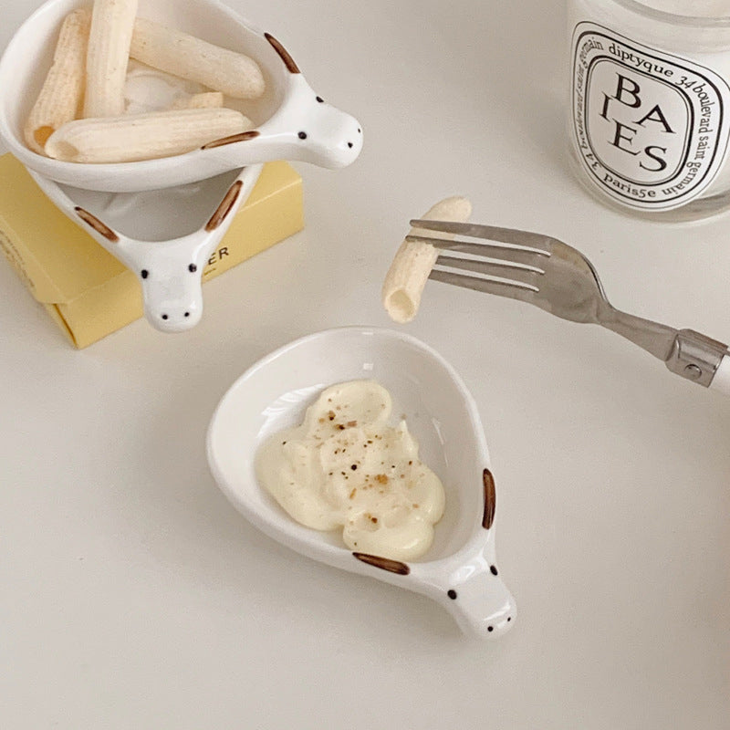 Cute household condiment dish with embossed design, ceramic vinegar dish, and various dipping sauces.