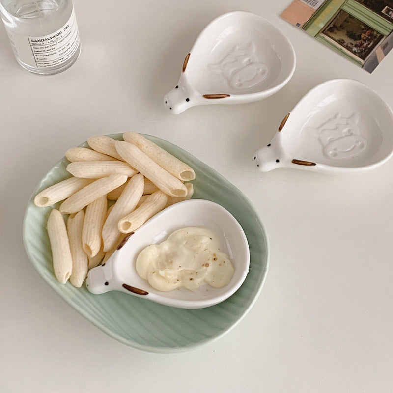 Cute household condiment dish with embossed design, ceramic vinegar dish, and various dipping sauces.