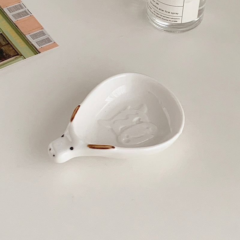 Cute household condiment dish with embossed design, ceramic vinegar dish, and various dipping sauces.