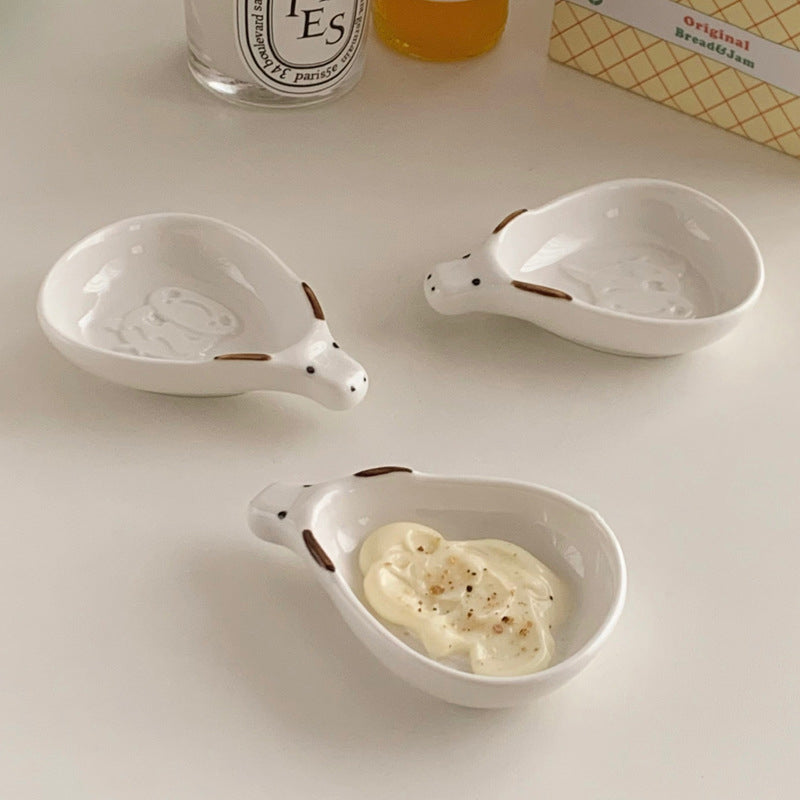 Cute household condiment dish with embossed design, ceramic vinegar dish, and various dipping sauces.