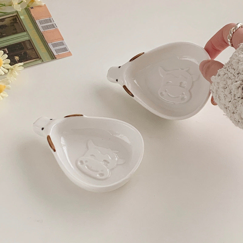 Cute household condiment dish with embossed design, ceramic vinegar dish, and various dipping sauces.